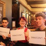 Three people holding up signs saying "innocent"