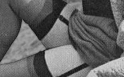 Grainy black and white picture of stockings and suspenders