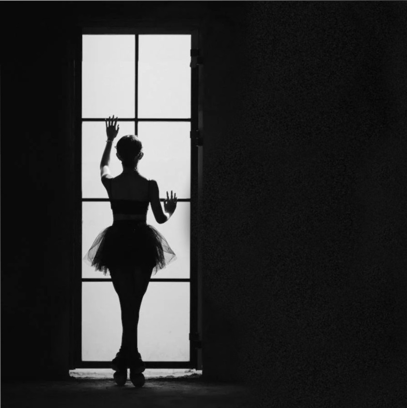 Silhouette of ballerina in window